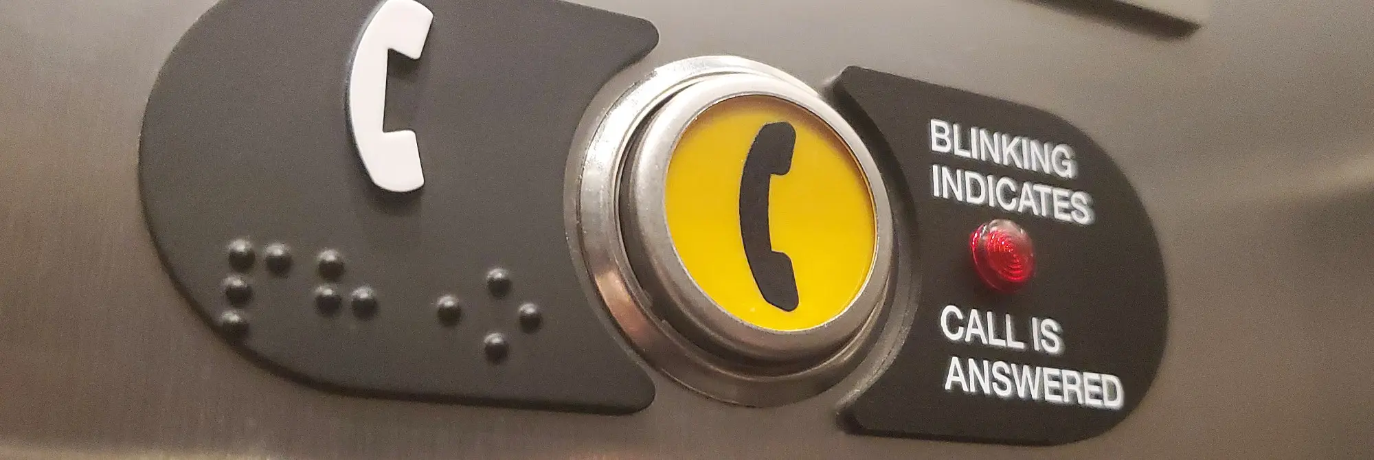 A close-up photo of an elevator phone button. 